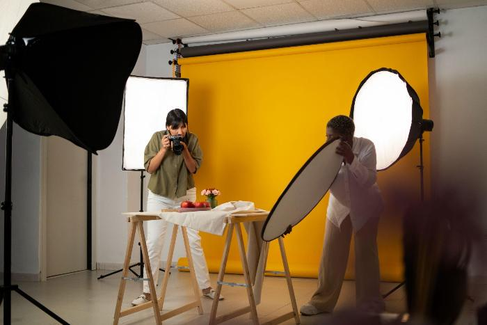 Photo shoot with two people, fruit arrangement, yellow background