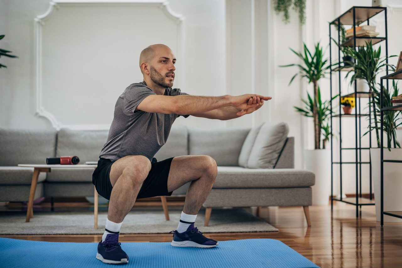 Image taken from a fitness YouTube video showing a man doing an at-home workout